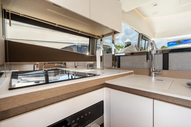 Soiral Yacht Photos Pics Modern kitchen interior on 2023 Prestige 520 yacht, featuring sleek design and high-end appliances.