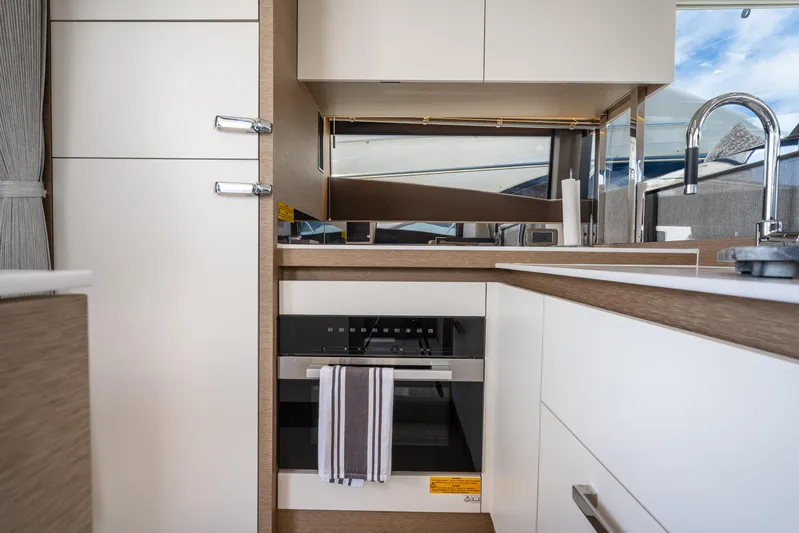 Soiral Yacht Photos Pics Modern kitchen interior of 2023 Prestige 520 yacht with sleek cabinetry and appliances.
