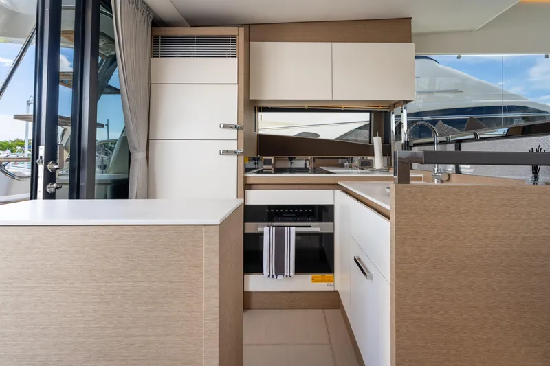 Soiral Yacht Photos Pics Modern kitchen interior on a 2023 Prestige 520 yacht, featuring sleek cabinetry and appliances.