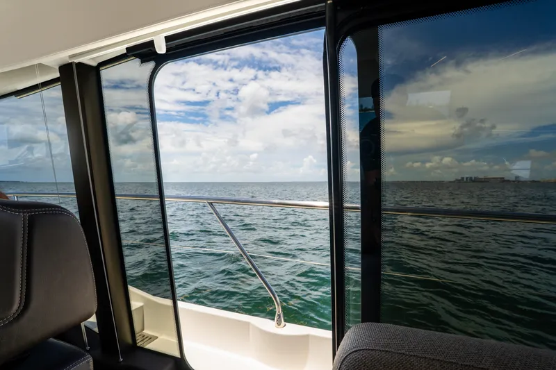 Soiral Yacht Photos Pics View from Prestige 520 yacht window, overlooking ocean and cloudy sky, 2023 model.