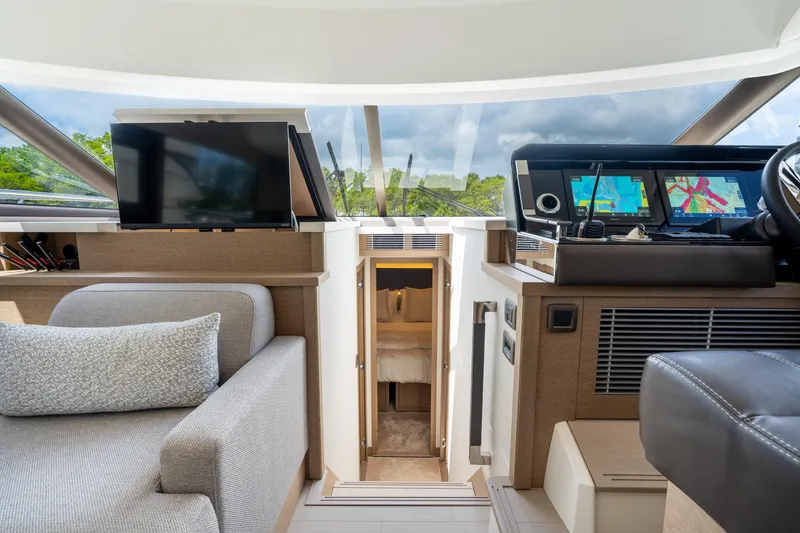 Soiral Yacht Photos Pics 2023 Prestige 520 yacht interior with modern navigation system and cozy seating area.