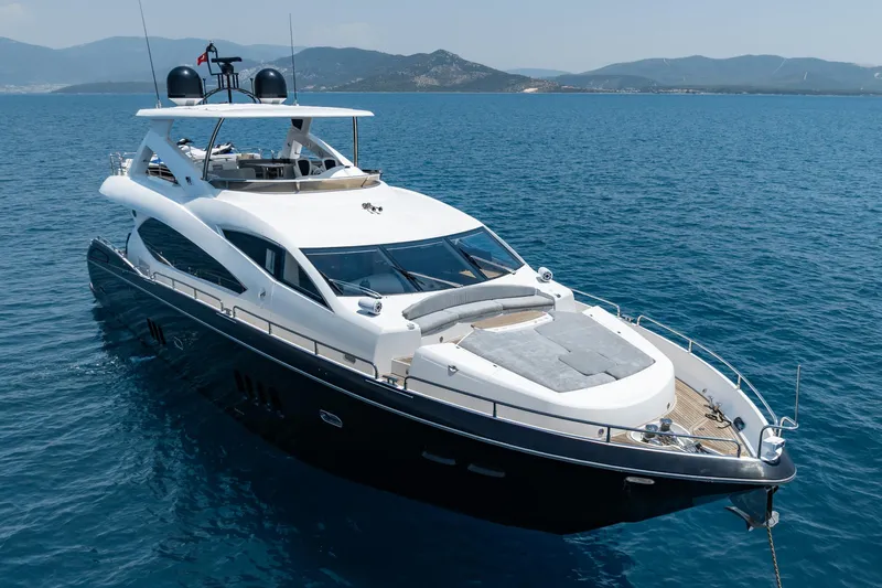 Mello Yacht Photos Pics 2008 Sunseeker 86 Yacht cruising on blue ocean waters with scenic mountain backdrop.