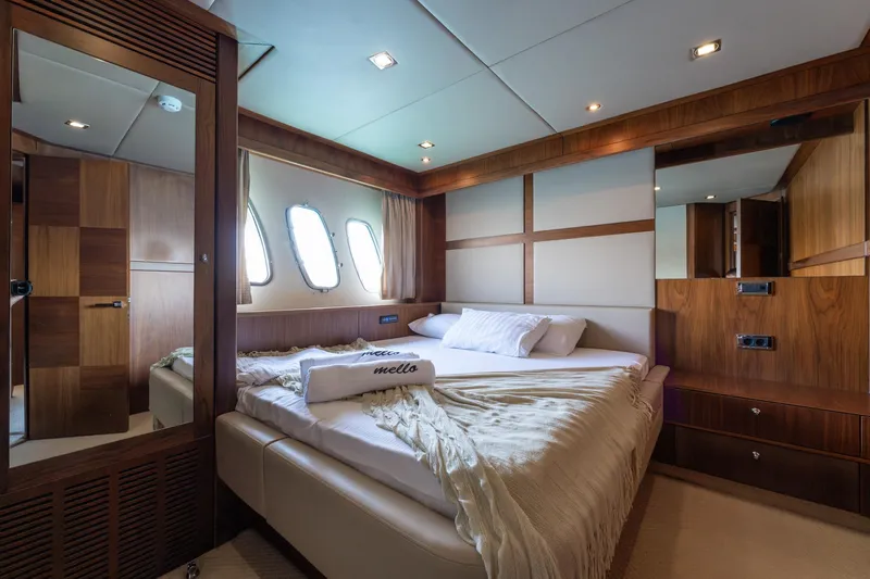 Mello Yacht Photos Pics Luxurious bedroom interior of 2008 Sunseeker 86 Yacht with elegant wood paneling.