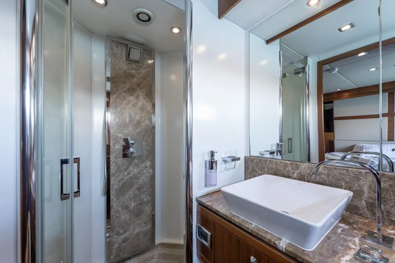 Mello Yacht Photos Pics Luxurious bathroom on a 2008 Sunseeker 86 Yacht with marble accents and modern fixtures.