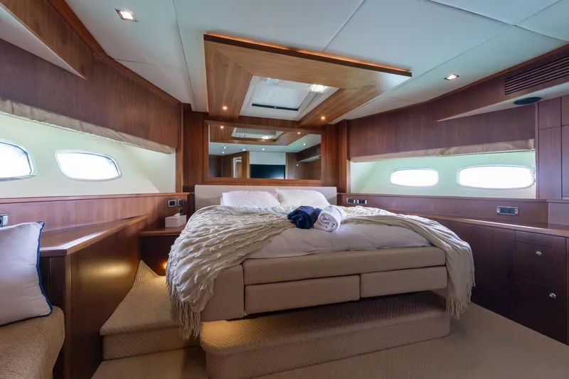 Mello Yacht Photos Pics Luxurious bedroom interior of 2008 Sunseeker 86 Yacht with elegant wood paneling.