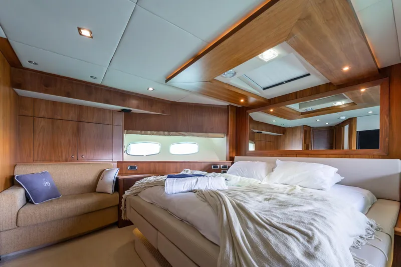 Mello Yacht Photos Pics Luxurious bedroom interior of 2008 Sunseeker 86 Yacht with wood paneling and cozy bedding.