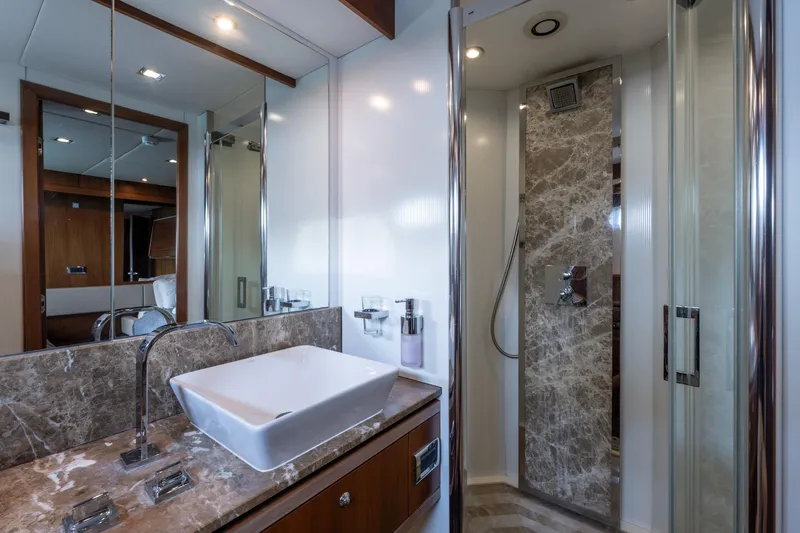 Mello Yacht Photos Pics Luxurious bathroom in 2008 Sunseeker 86 Yacht with marble accents and modern fixtures.
