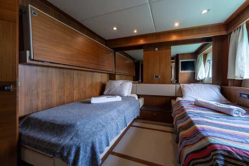 Mello Yacht Photos Pics Luxurious cabin interior of 2008 Sunseeker 86 Yacht with twin beds and wood paneling.