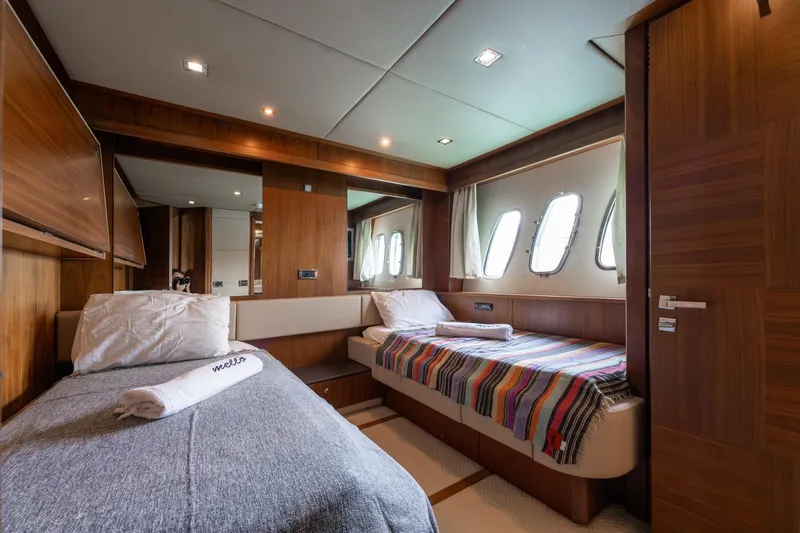 Mello Yacht Photos Pics Luxurious cabin interior of 2008 Sunseeker 86 Yacht with twin beds and elegant wood finish.