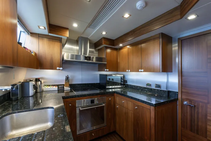 Mello Yacht Photos Pics Luxurious kitchen interior of 2008 Sunseeker 86 Yacht with modern appliances and wood cabinetry.