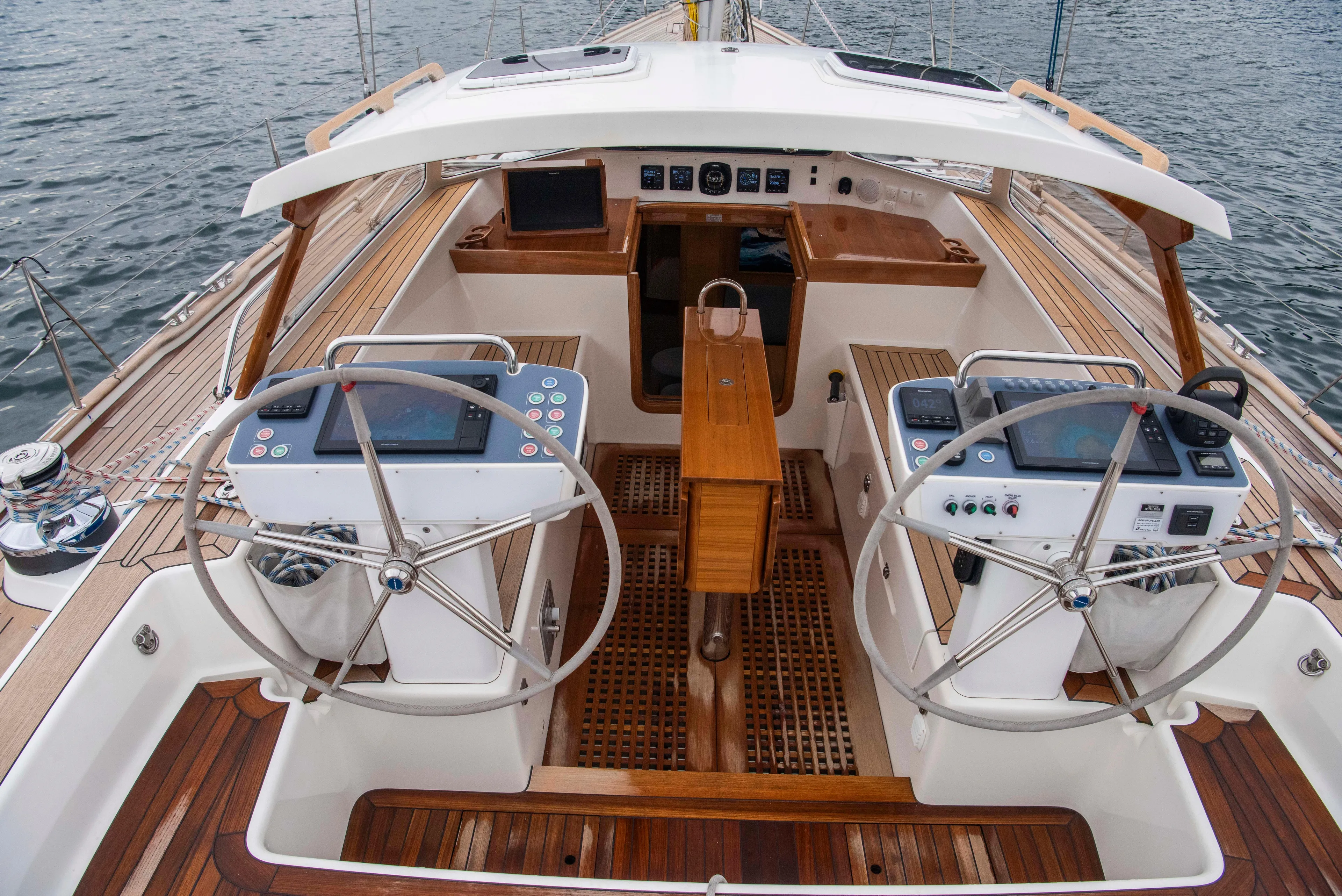 Hallberg Rassy 57 2020 Yacht Photos Pics Cockpit of 2020 Hallberg-Rassy 57 yacht with dual steering wheels and navigation controls.