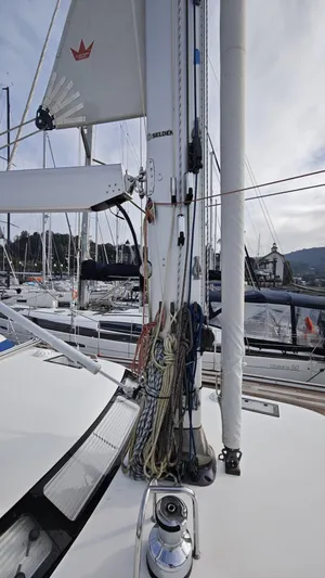 Hallberg Rassy 57 2020 Yacht Photos Pics 2020 Hallberg-Rassy 57 sailboat mast and rigging in marina setting.