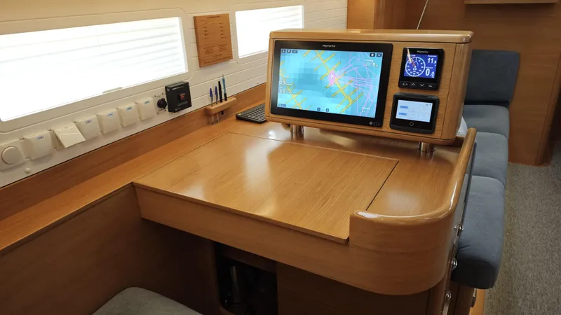 Hallberg Rassy 57 2020 Yacht Photos Pics Navigation station of 2020 Hallberg-Rassy 57 yacht with modern touchscreen display.