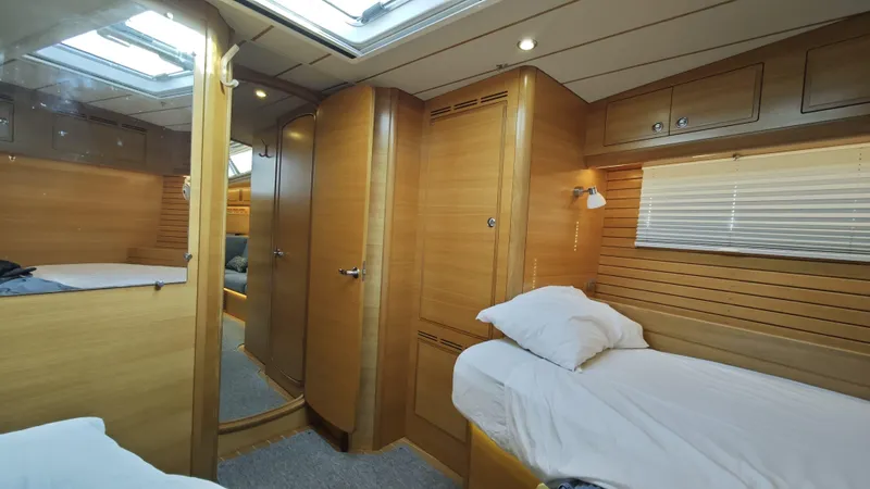 Hallberg Rassy 57 2020 Yacht Photos Pics Luxurious 2020 Hallberg-Rassy 57 yacht interior with wooden finish and cozy sleeping area.