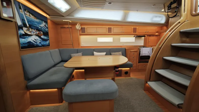 Hallberg Rassy 57 2020 Yacht Photos Pics Luxurious 2020 Hallberg-Rassy 57 yacht interior with cozy seating and elegant wood finishes.