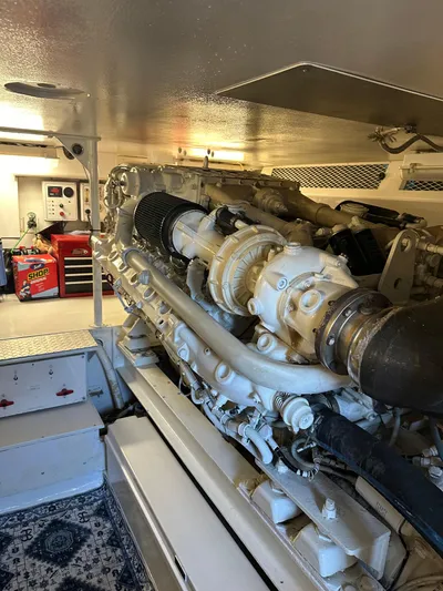 A2z's Yacht Photos Pics Engine room of 1999 Viking 55 Convertible yacht, showcasing powerful machinery and organized workspace.