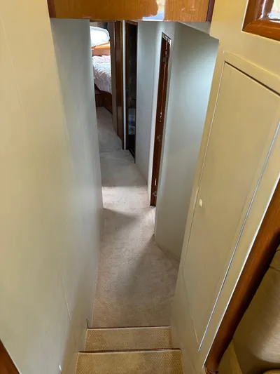 A2z's Yacht Photos Pics Interior hallway of 1999 Viking 55 Convertible yacht with carpeted flooring.