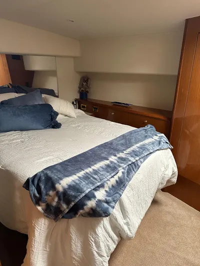 A2z's Yacht Photos Pics Cozy bedroom interior of 1999 Viking 55 Convertible yacht with plush bedding.