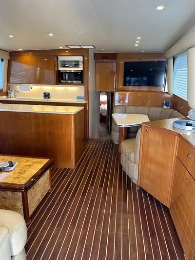 A2z's Yacht Photos Pics Luxurious interior of a 1999 Viking 55 Convertible yacht with wood finishes and modern amenities.