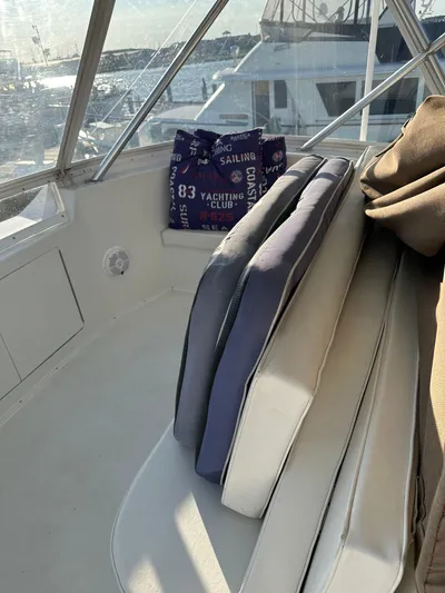 A2z's Yacht Photos Pics 1999 Viking 55 Convertible boat interior with stacked cushions and nautical-themed bag.