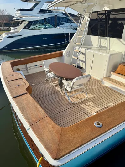 A2z's Yacht Photos Pics 1999 Viking 55 Convertible yacht with wooden deck and seating area.