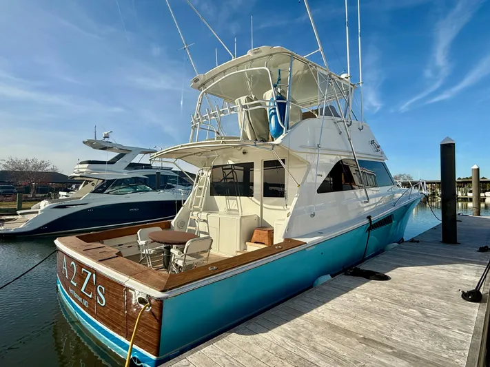 A2z's Yacht Photos Pics 1999 Viking 55 Convertible yacht docked at marina under clear blue sky.