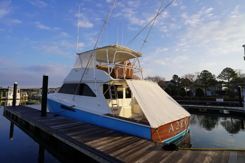 A2z's Yacht Photos Pics 1999 Viking 55 Convertible yacht docked at marina under clear sky.