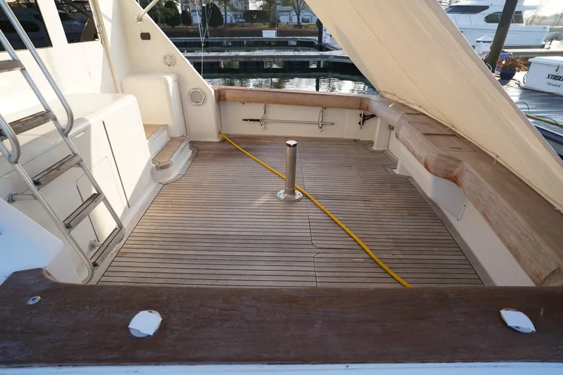 A2z's Yacht Photos Pics 1999 Viking 55 Convertible yacht deck with wooden flooring and seating area.