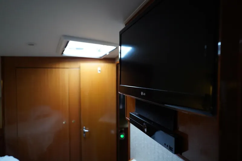 A2z's Yacht Photos Pics Interior of 1999 Viking 55 Convertible yacht with wall-mounted LG TV.