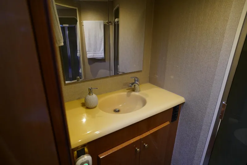 A2z's Yacht Photos Pics Bathroom interior of 1999 Viking 55 Convertible yacht with sink and mirror.