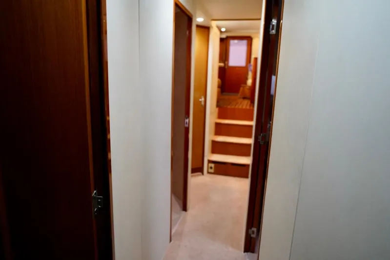 A2z's Yacht Photos Pics Interior hallway of 1999 Viking 55 Convertible yacht with wooden doors and stairs.