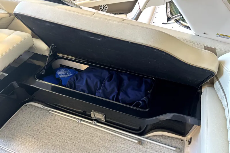  Yacht Photos Pics Open storage compartment in 2019 Regal 2800 Bowrider boat with blue bag inside.