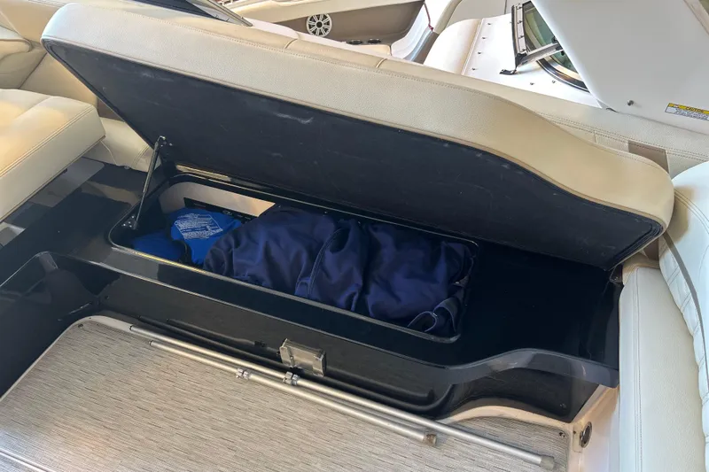  Yacht Photos Pics Open storage compartment in 2019 Regal 2800 Bowrider boat with beige seating.
