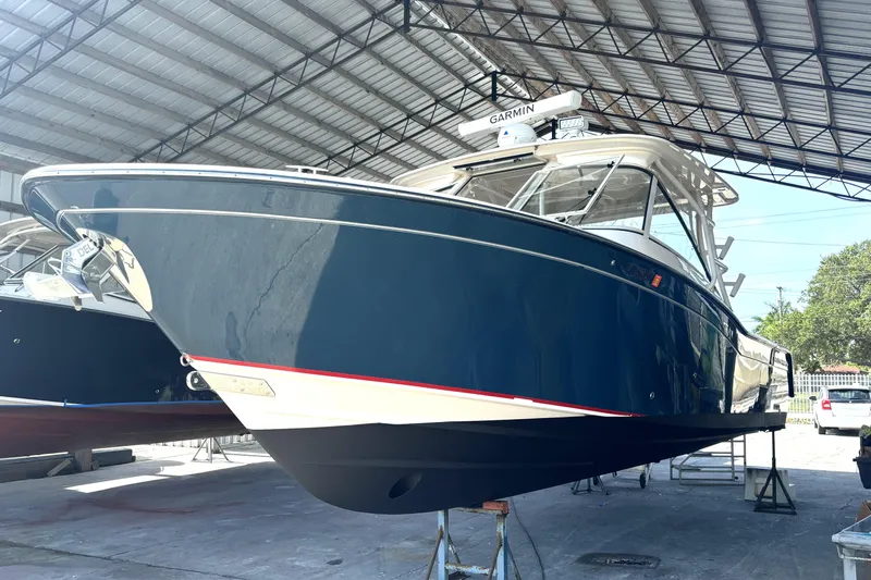 325-708 Brokerage Josh Yacht Photos Pics 2021 Grady-White Freedom 325 boat in a covered storage area.