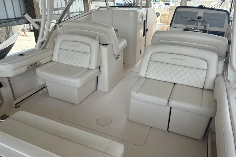 325-708 Brokerage Josh Yacht Photos Pics 2021 Grady-White Freedom 325 boat interior with white seating and Garmin navigation.
