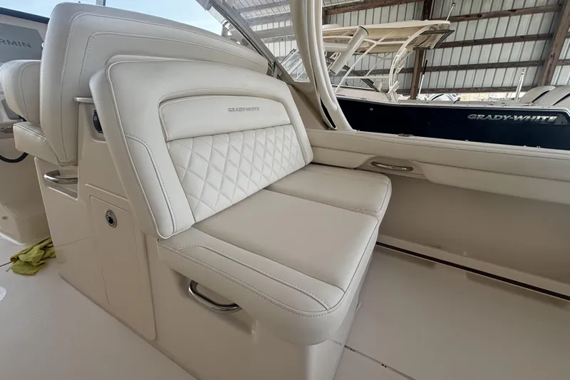 325-708 Brokerage Josh Yacht Photos Pics 2021 Grady-White Freedom 325 boat interior with luxurious white seating.