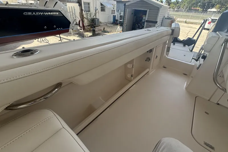 325-708 Brokerage Josh Yacht Photos Pics 2021 Grady-White Freedom 325 boat interior with beige seating and stainless steel accents.