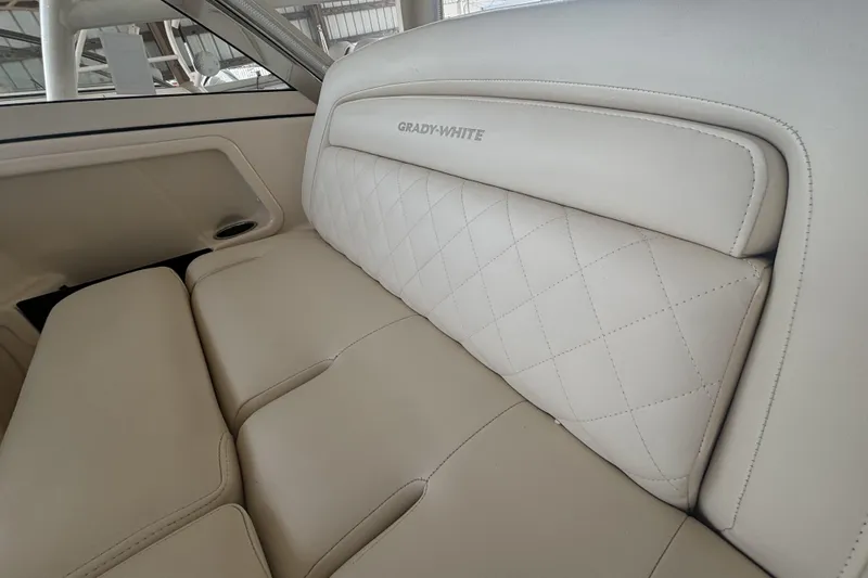 325-708 Brokerage Josh Yacht Photos Pics 2021 Grady-White Freedom 325 boat interior with luxurious beige leather seating.
