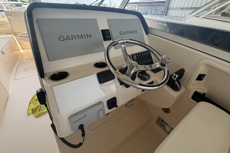 325-708 Brokerage Josh Yacht Photos Pics 2021 Grady-White Freedom 325 helm with Garmin displays and steering wheel.