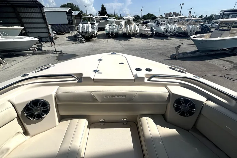 325-708 Brokerage Josh Yacht Photos Pics 2021 Grady-White Freedom 325 boat interior at a marina with multiple boats.