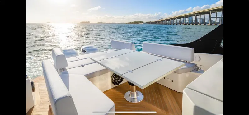  Yacht Photos Pics Luxury FIM 340 REGINA yacht deck with seating, ocean view, and bridge in the background.