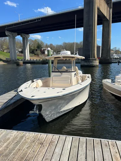 Next Level Yacht Photos Pics 2019 Grady-White Canyon 306 boat docked under a bridge on a sunny day.