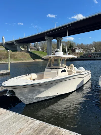 Next Level Yacht Photos Pics 2019 Grady-White Canyon 306 boat docked under a bridge on a sunny day.