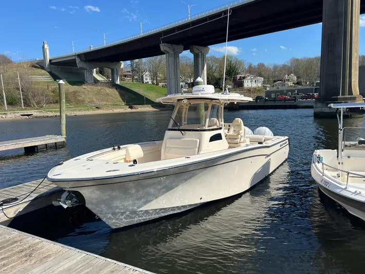Next Level Yacht Photos Pics 2019 Grady-White Canyon 306 boat docked under a bridge on a sunny day.