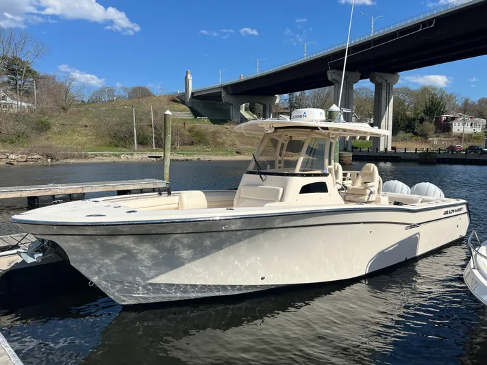 Next Level Yacht Photos Pics 2019 Grady-White Canyon 306 boat docked under a bridge on a sunny day.