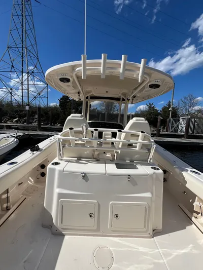 Next Level Yacht Photos Pics 2019 Grady-White Canyon 306 boat interior with seating and storage, under a clear blue sky.