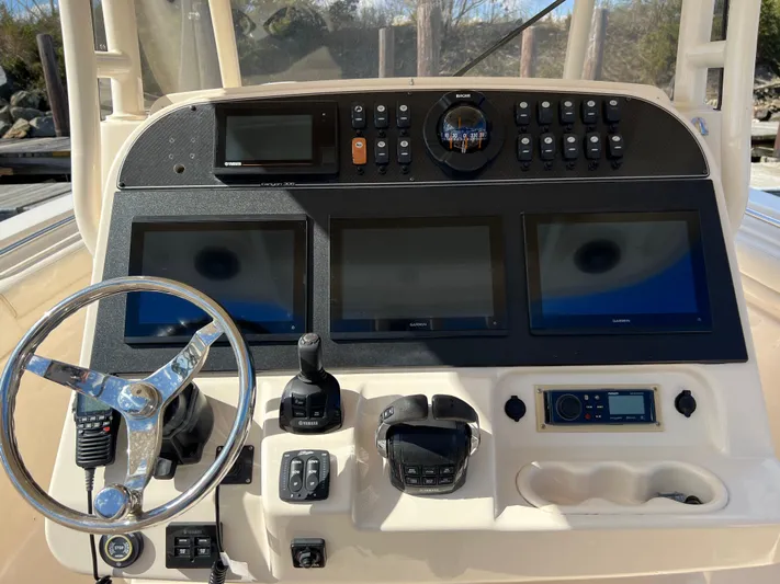 Next Level Yacht Photos Pics 2019 Grady-White Canyon 306 helm with steering wheel, Garmin displays, and control panel.