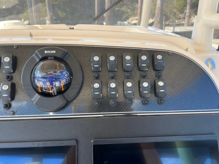 Next Level Yacht Photos Pics Control panel of 2019 Grady-White Canyon 306 boat with compass and switches.