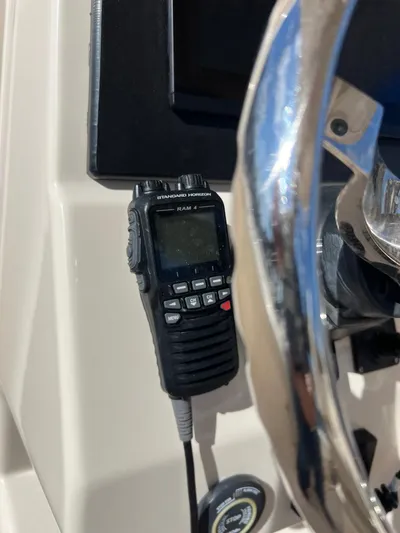 Next Level Yacht Photos Pics Handheld radio on 2019 Grady-White Canyon 306 boat dashboard near steering wheel.