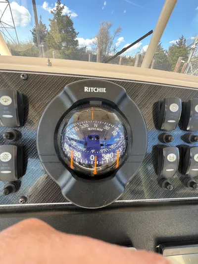 Next Level Yacht Photos Pics Compass on 2019 Grady-White Canyon 306 boat dashboard with control switches.